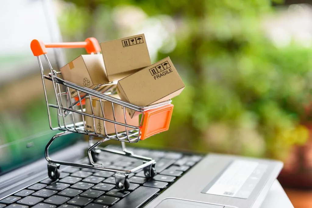 Photo of a mini shopping cart containing four mini cardboard boxes illustrating average order value