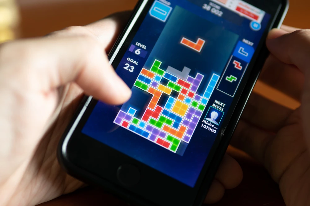 closeup of a tetris-like puzzle video game being played on a mobile phone