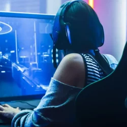 photo of a female video gamer sitting in a chair