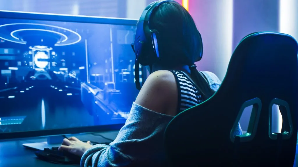 photo of a female video gamer sitting in a chair