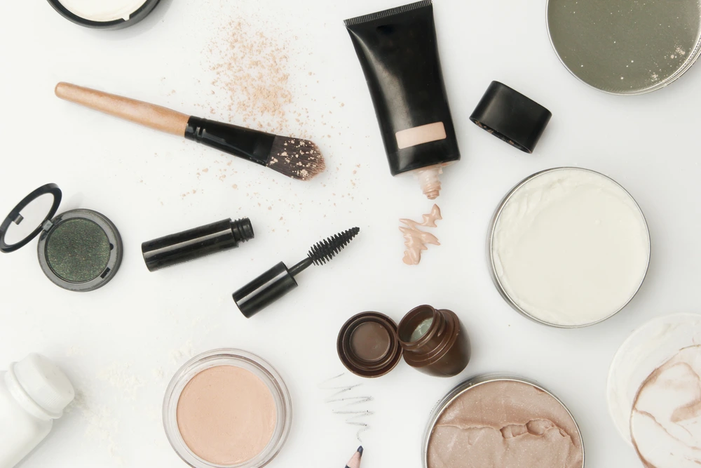 an overhead shot of beauty brand products on a white background