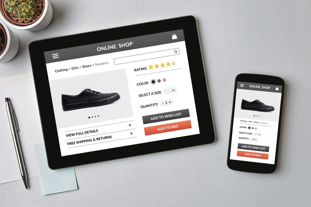 photo of a tablet and mobile phone showing a black shoe for sale on an ecommerce site