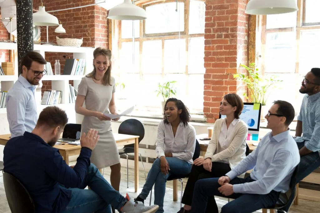 A group of young professionals meet in an open office