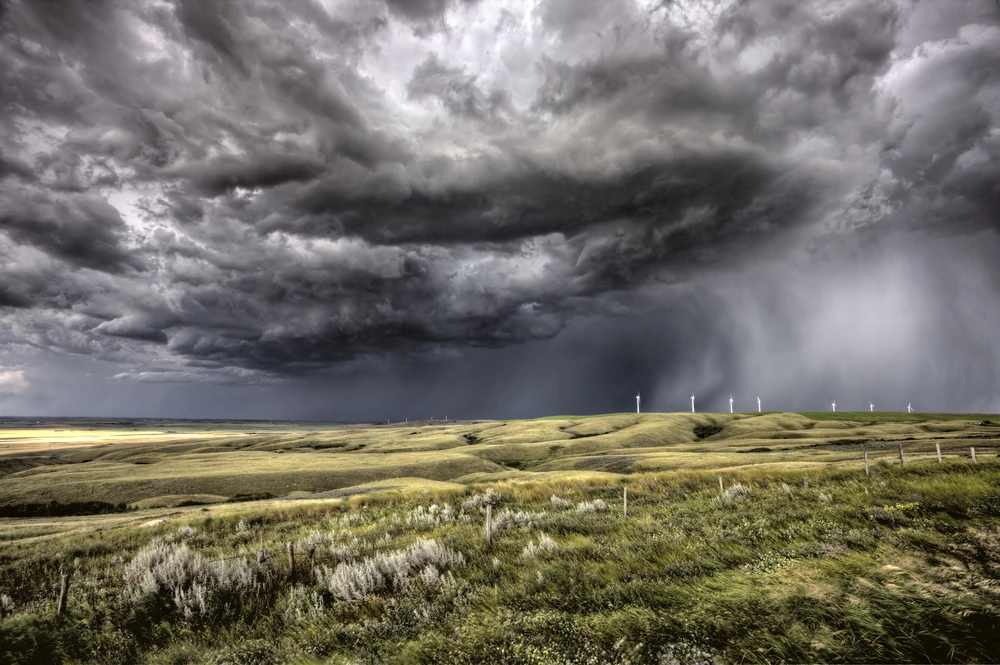 photo of low-hanging, ominous storm clouds over a prairie landscape