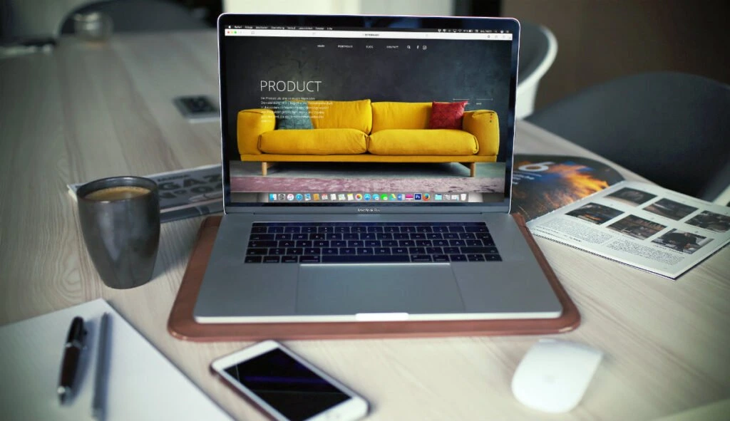 an open laptop displaying an enterprise ecommerce site that sells sofas