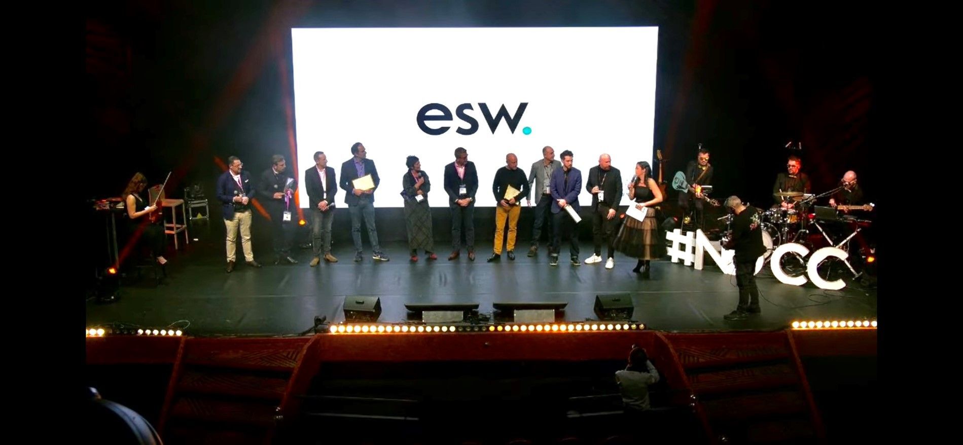 The ESW Team stands on a stage accepting the nuit-du-commerce-connecte award