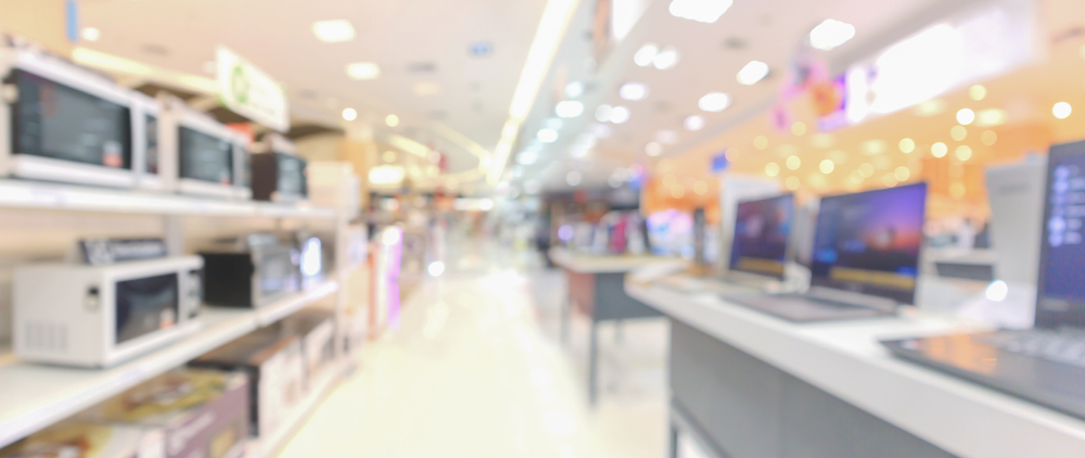 blurred view of consumer electronics in a retail store