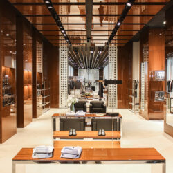 Photo of the interior of a wood and chrome trimmed luxury retail store
