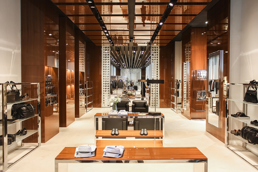 Photo of the interior of a wood and chrome trimmed luxury retail store