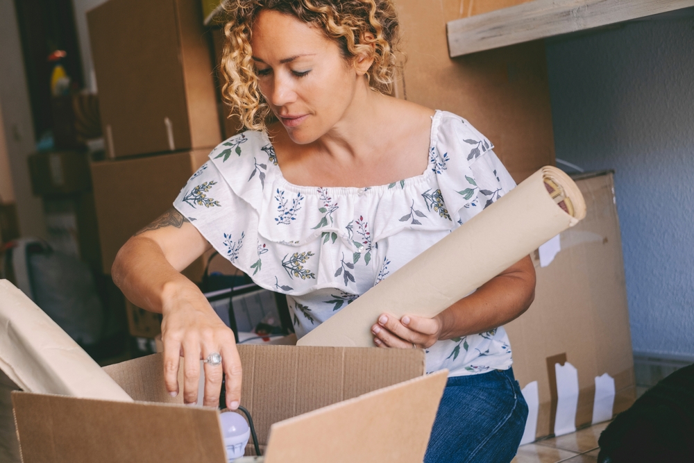 a woman opens a delivery of an online purchase