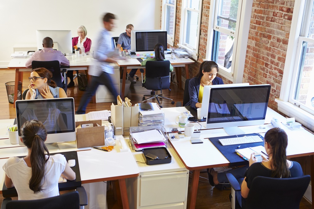 an office scene with employees at desks