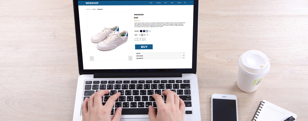 a man add sneakers to his online cart