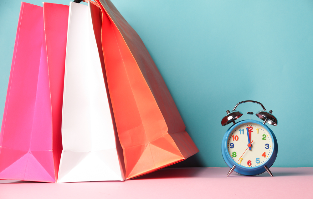 shopping bags next to an alarm clock